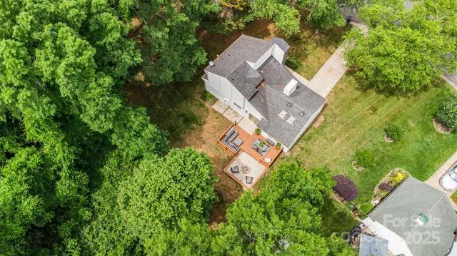 an aerial view of a house with a yard and garden