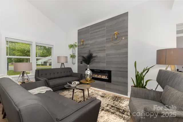 a living room with furniture and a fireplace