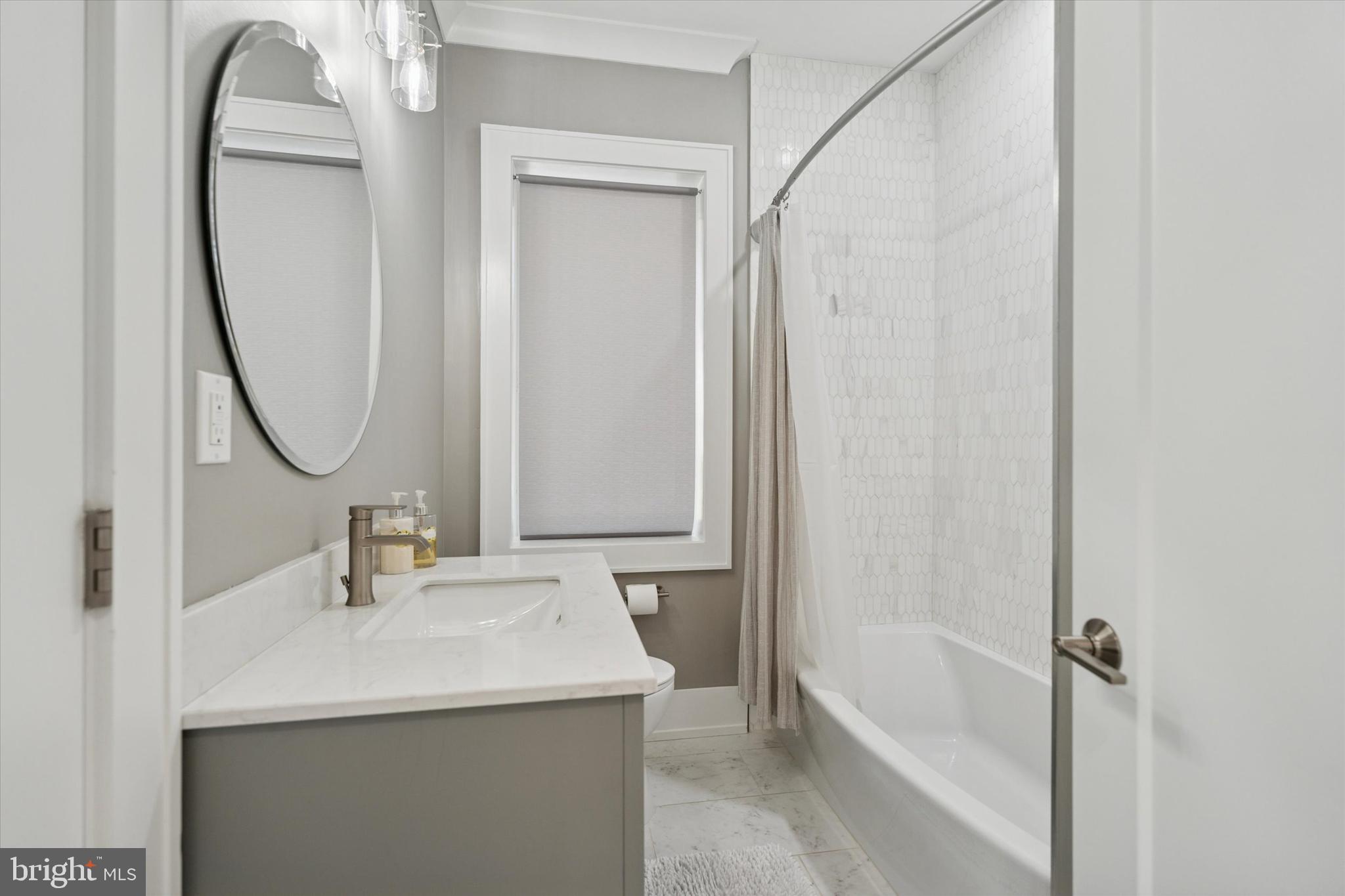 820 Darby Paoli Road Newtown Square, PA 19073 - Photo 24 of 36 a bathroom with a sink vanity tub and a mirror