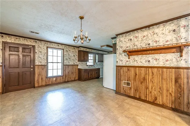 a view of a livingroom with a chandelier fan and closet area