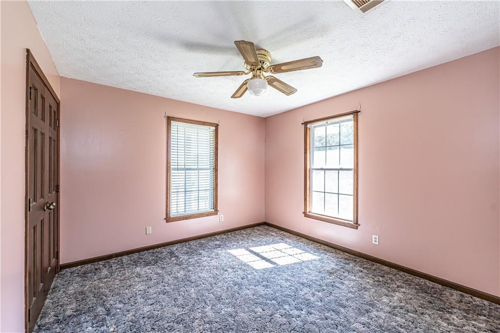 838 Pleasant Hope Road Southeast Silver Creek, GA 30173 - Photo 19 of 30 an empty room with windows and fan