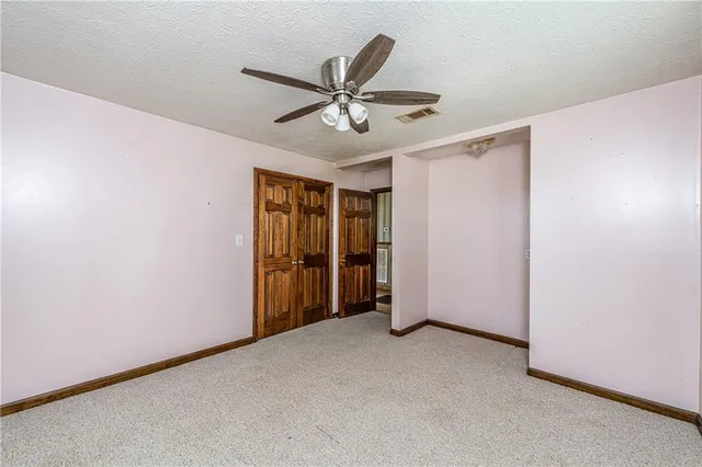 a view of an empty room with windows