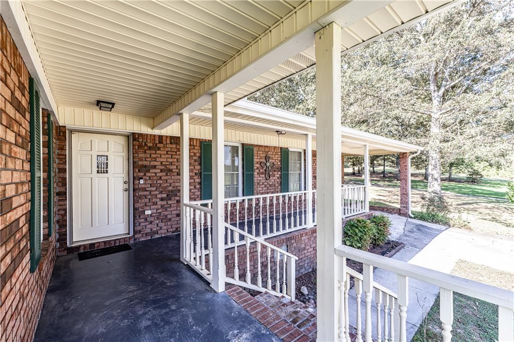 838 Pleasant Hope Road Southeast Silver Creek, GA 30173 - Photo 3 of 30 a view of a porch with wooden floor and fence