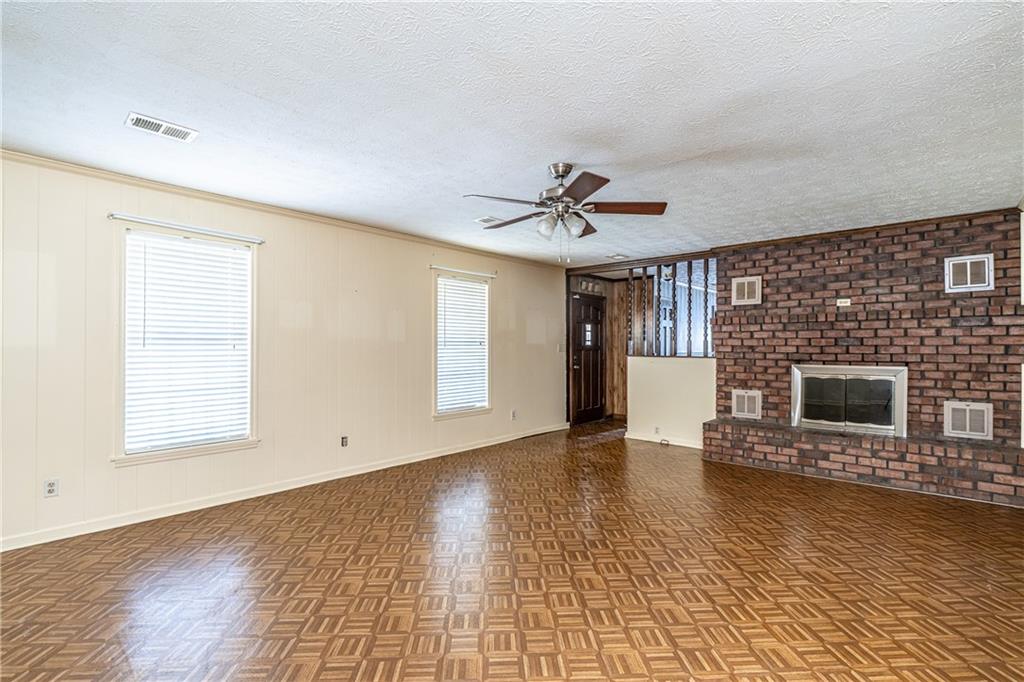 838 Pleasant Hope Road Southeast Silver Creek, GA 30173 - Photo 8 of 30 a view of an empty room with a fireplace and a window