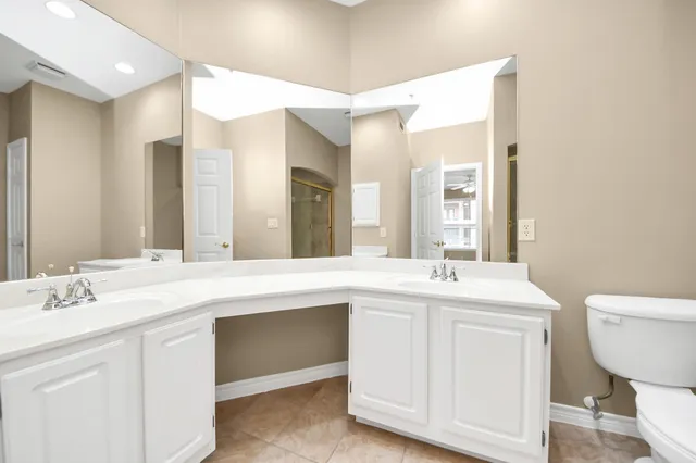 a bathroom with a tub sink and mirror