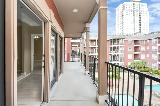a view of a big room with closet and wooden door