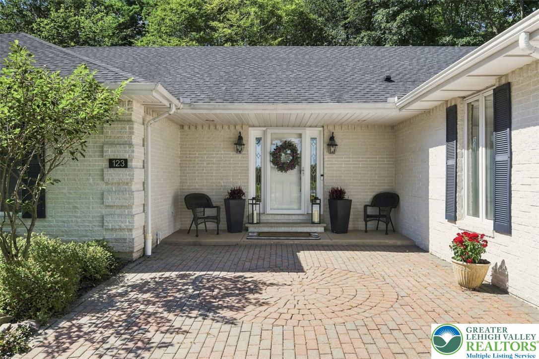 123 Meadow Road Blakeslee, PA 18610 - Photo 3 of 53 An inviting brick entry courtyard welcomes guests with detailed paver flooring and classic shutters.