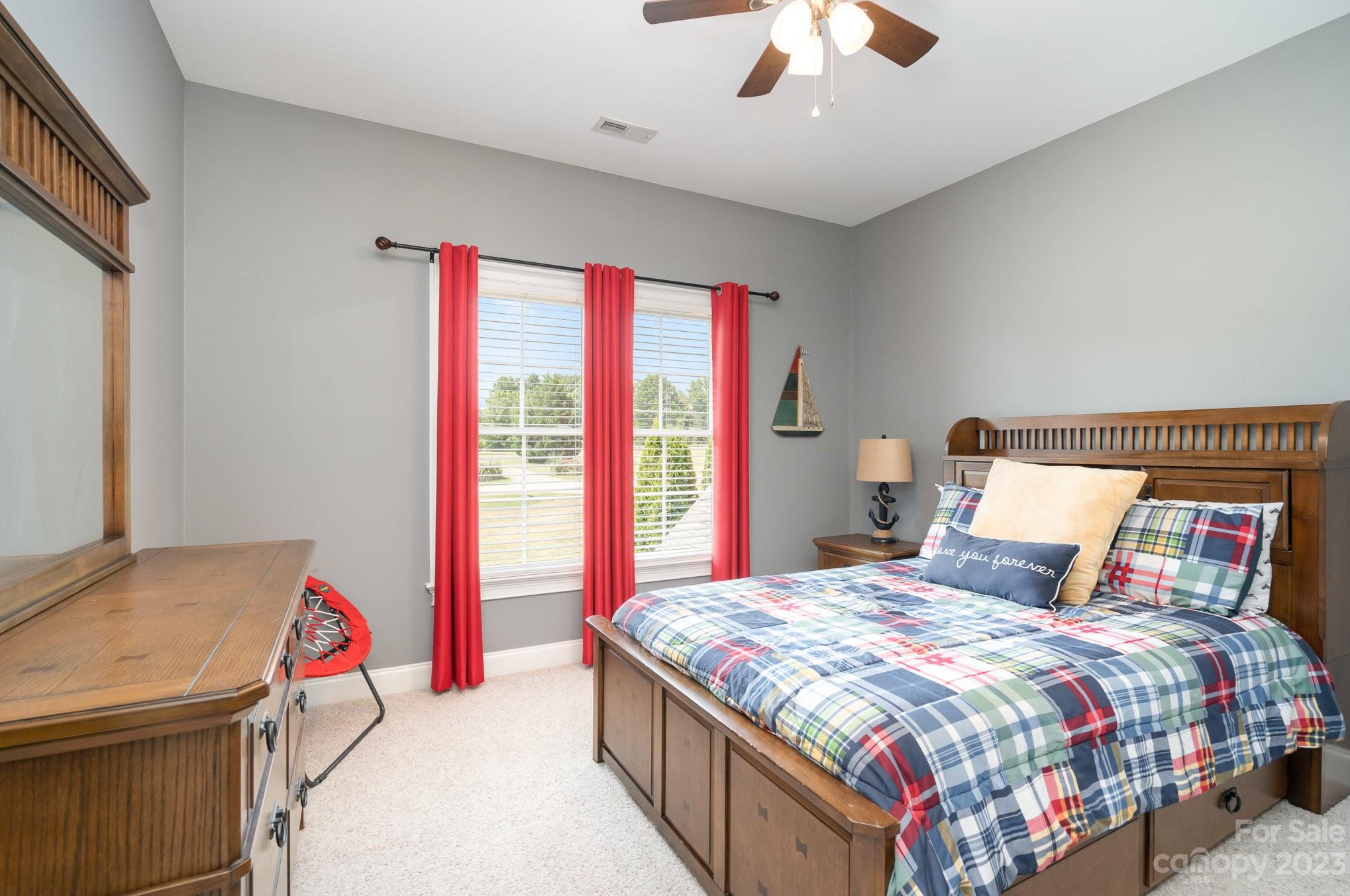 4502 Gold Hill Road Concord, NC 28025 - Photo 28 of 48 a bedroom with a bed and a chandelier
