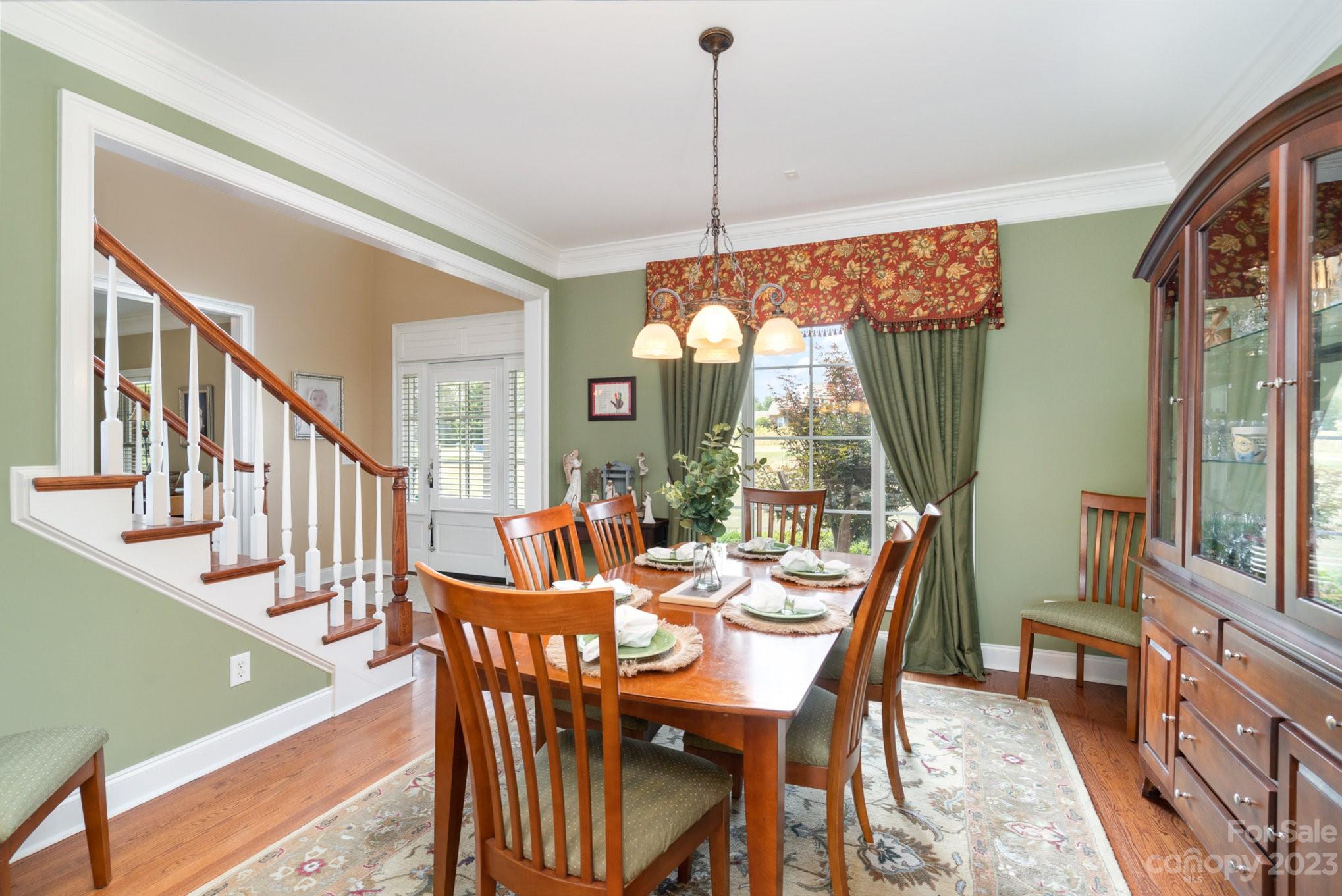 4502 Gold Hill Road Concord, NC 28025 - Photo 7 of 48 a dining room with furniture a chandelier and a rug