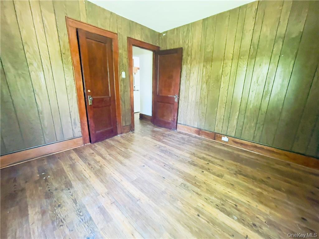 4 Old Turnpike Road Bloomingburg, NY 12721 - Photo 12 of 27 Spare room with wooden walls and hardwood / wood-style flooring