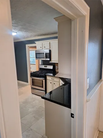 a kitchen with stainless steel appliances a refrigerator and a stove