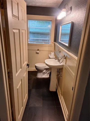 a bathroom with a sink a mirror and a toilet