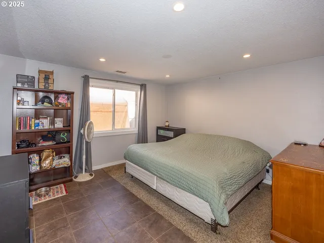 a bed sitting in a room next to a window