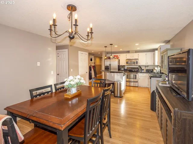 a view of a dining room kitchen counter top space a sink and appliances