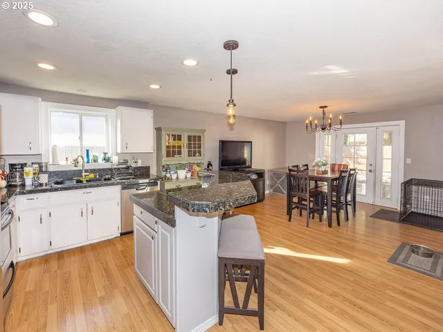 a kitchen with lots of counter top space and dining table