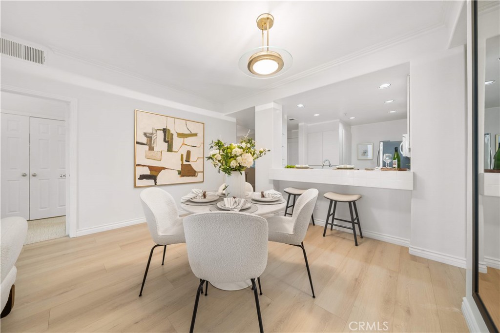 2233 Martin, Unit 204 Irvine, CA 92612 - Photo 14 of 41 a dining room with furniture and wooden floor