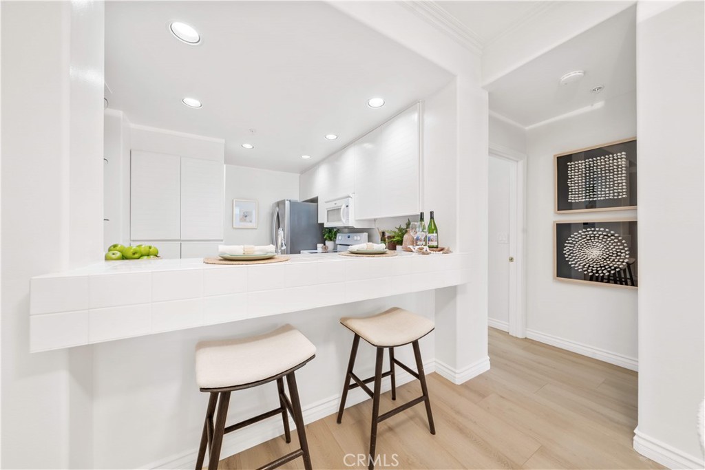 2233 Martin, Unit 204 Irvine, CA 92612 - Photo 8 of 41 a kitchen with kitchen island cabinets and wooden floor