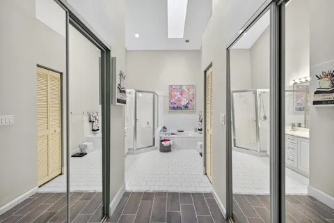 a very nice looking an empty room with wooden floor and a bathroom