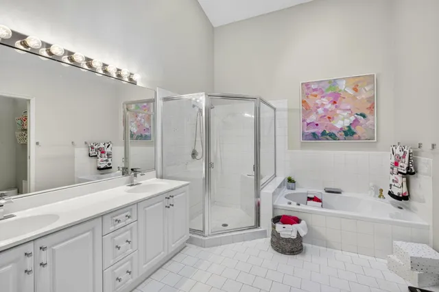 a bathroom with a double vanity sink mirror and shower