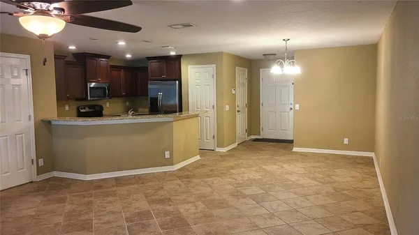 a view of a kitchen with a sink and cabinets