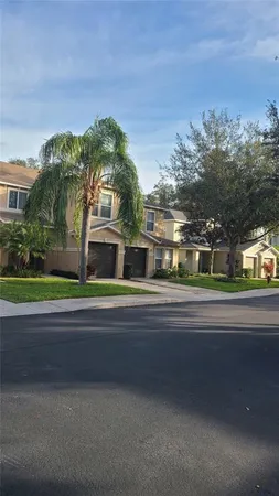 a multi story building with trees in front of it