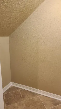 a kitchen with granite countertop a refrigerator and a stove top oven