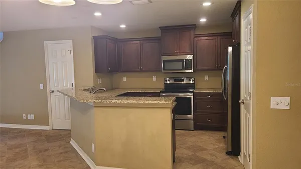 a kitchen with a refrigerator sink and microwave