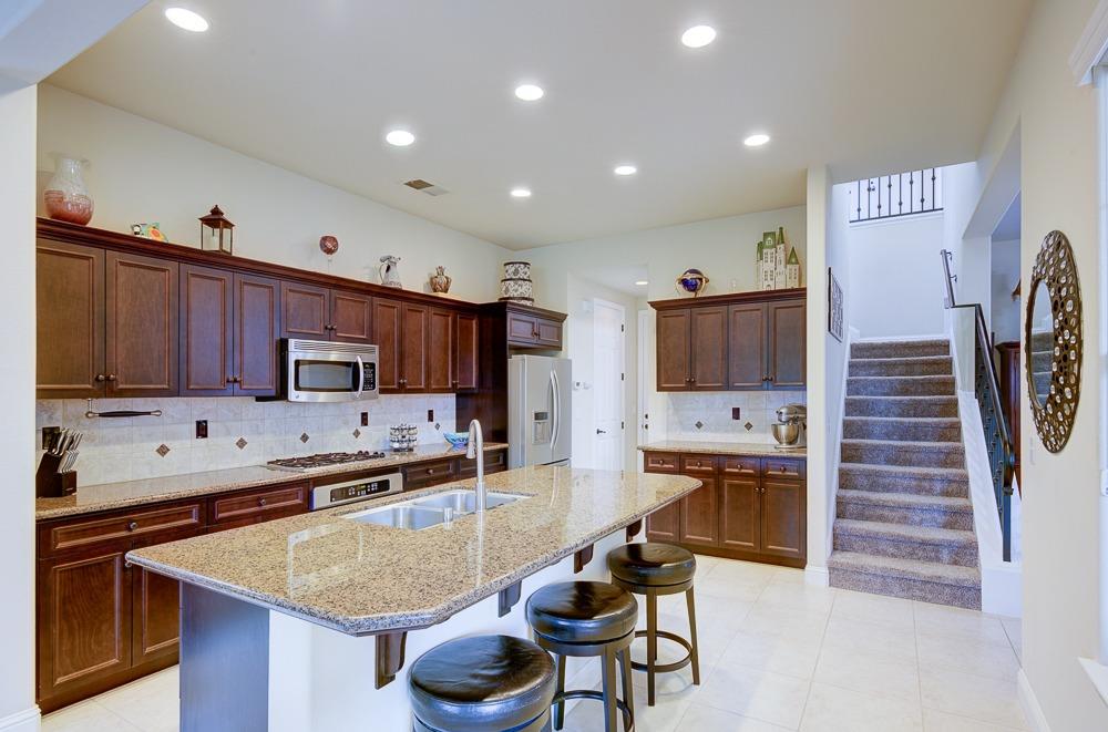 3852 Harlan Ranch Boulevard Clovis, CA 93619 - Photo 14 of 45 a kitchen with stainless steel appliances granite countertop a sink and a refrigerator