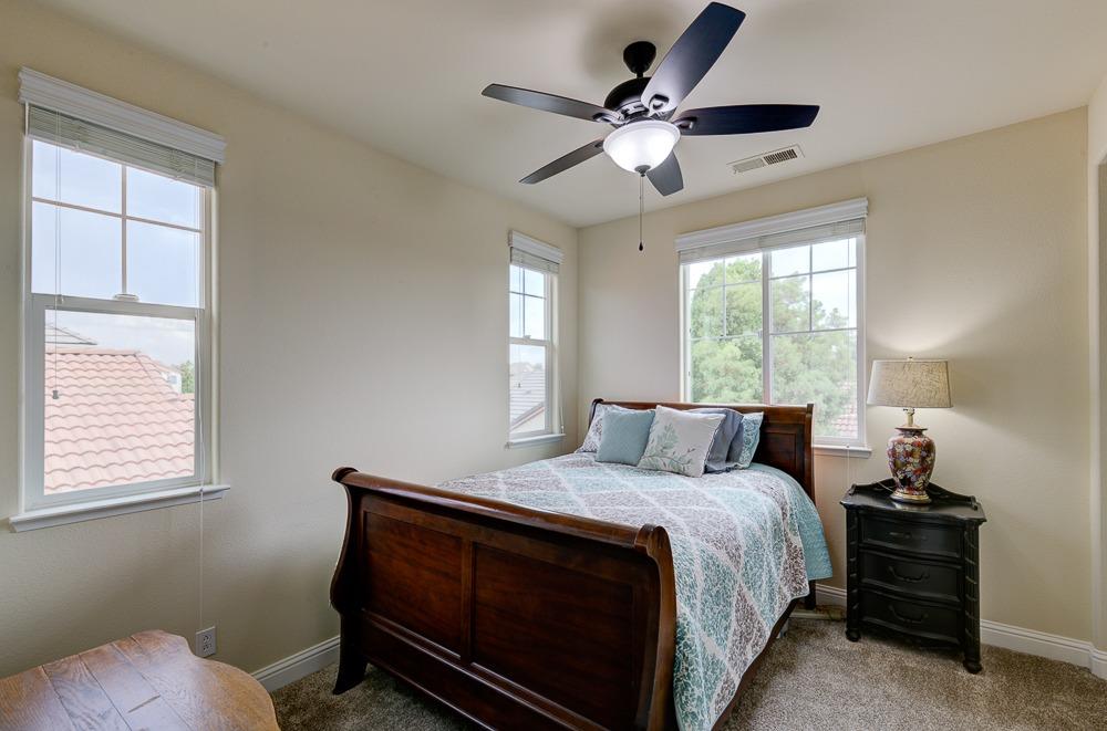 3852 Harlan Ranch Boulevard Clovis, CA 93619 - Photo 27 of 45 a bedroom with a bed and window