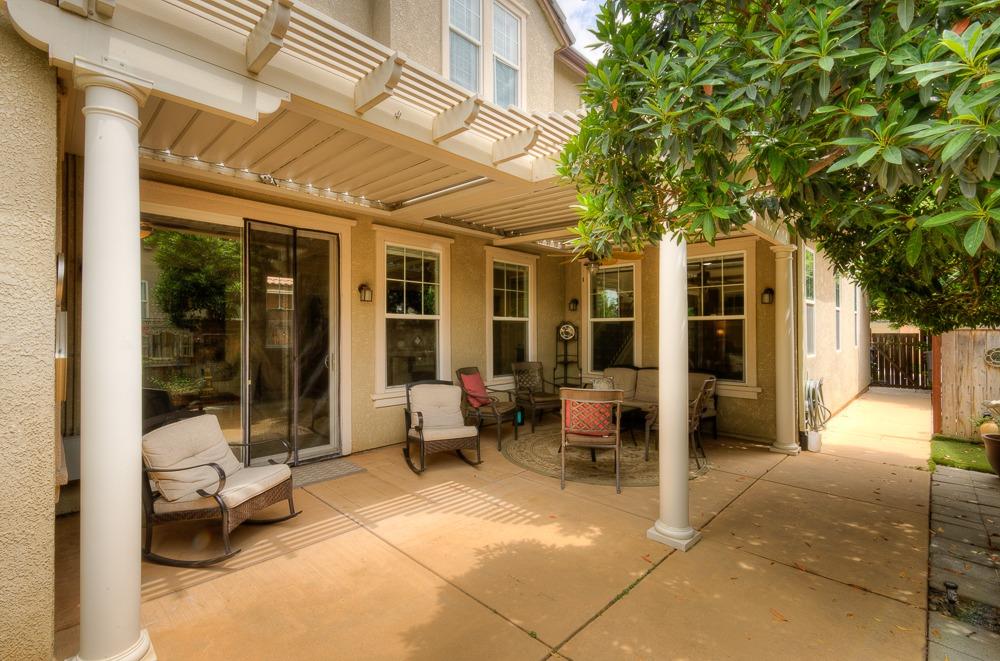 3852 Harlan Ranch Boulevard Clovis, CA 93619 - Photo 37 of 45 a view of a patio with table and chairs next to a large window