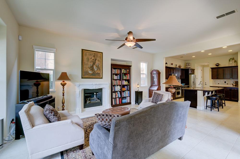 3852 Harlan Ranch Boulevard Clovis, CA 93619 - Photo 7 of 45 a living room with fireplace furniture and a flat screen tv