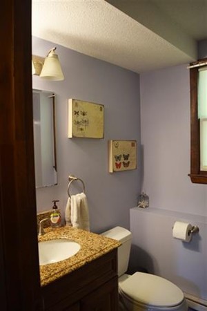 24 Derryfield Road, Unit L Derry, NH 03038 - Photo 5 of 10 a bathroom with a granite countertop toilet and a sink