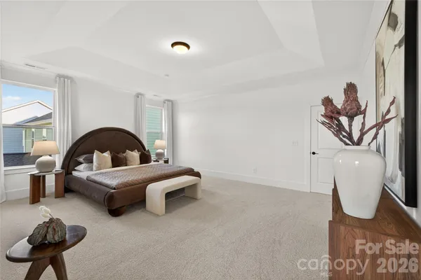a living room with furniture and a painting on the wall