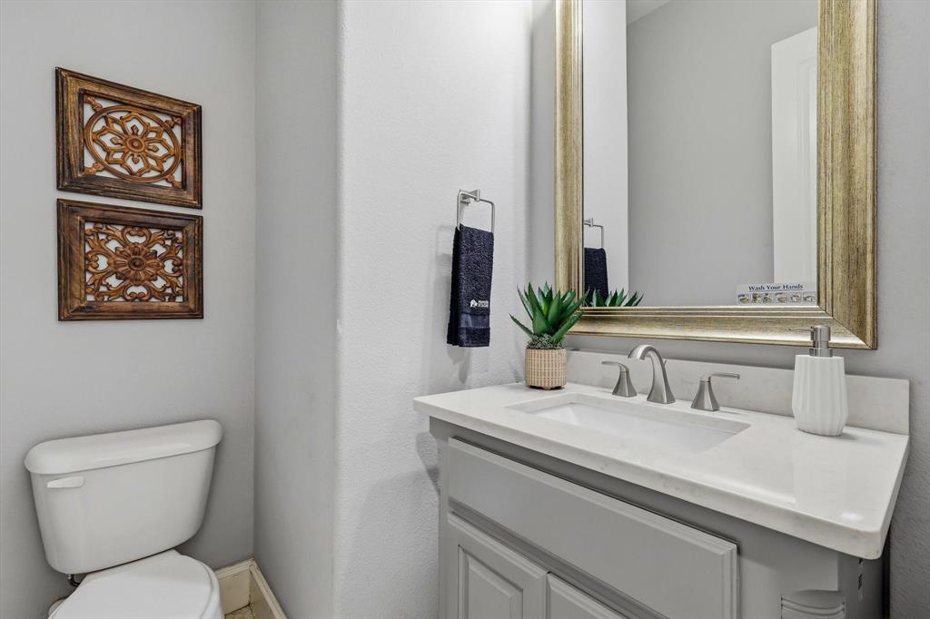 1933 Snapdragon Road Frisco, TX 75033 - Photo 28 of 40 Vanity with an integrated rectangular sink, light-toned countertop, and brushed nickel faucet