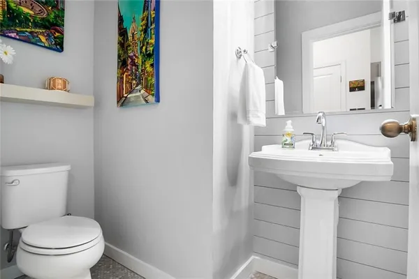 a bathroom with a sink a toilet and mirror
