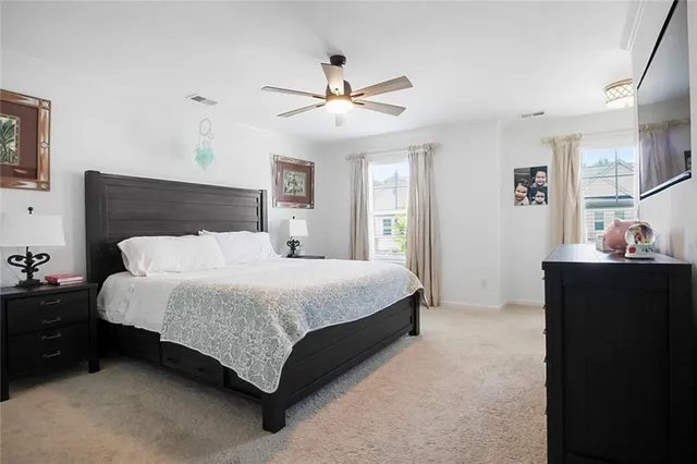 a bed room with a bed and a ceiling fan