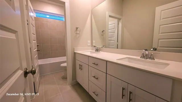 a spacious bathroom with a double vanity sink mirror and double