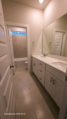 a bathroom with a granite countertop sink a toilet and a bathtub