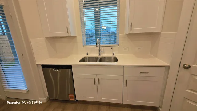 a kitchen with a sink and cabinets
