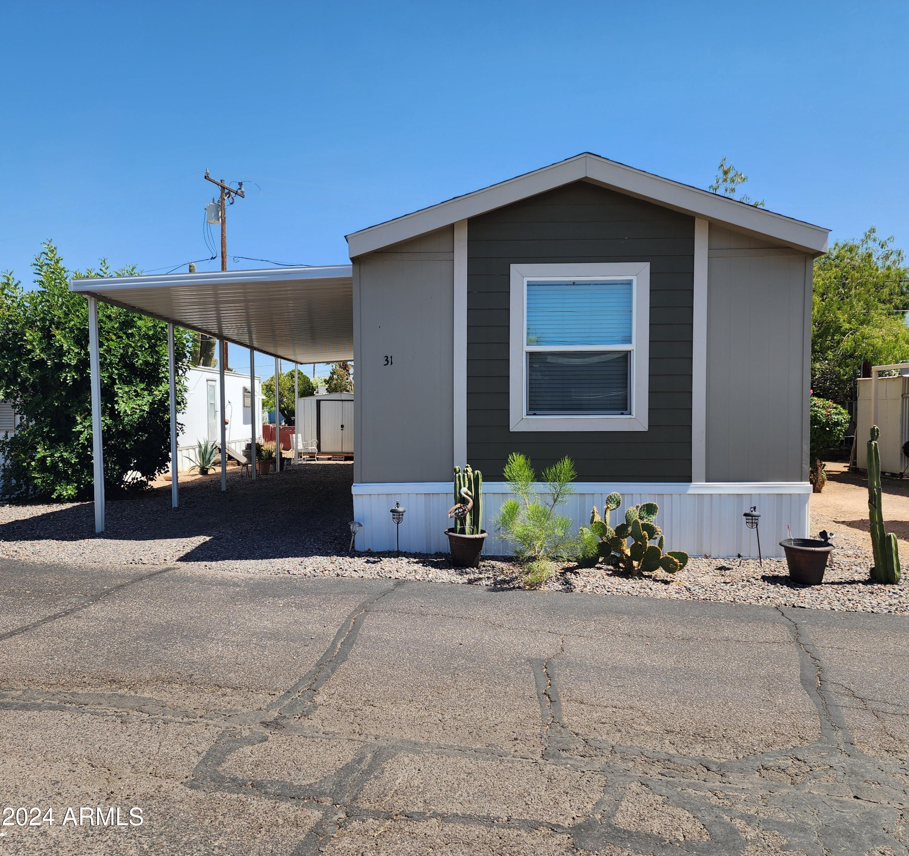 16005 North 32nd Street, Unit 31 Phoenix, AZ 85032 - Photo 1 of 48 a front view of a house with a yard