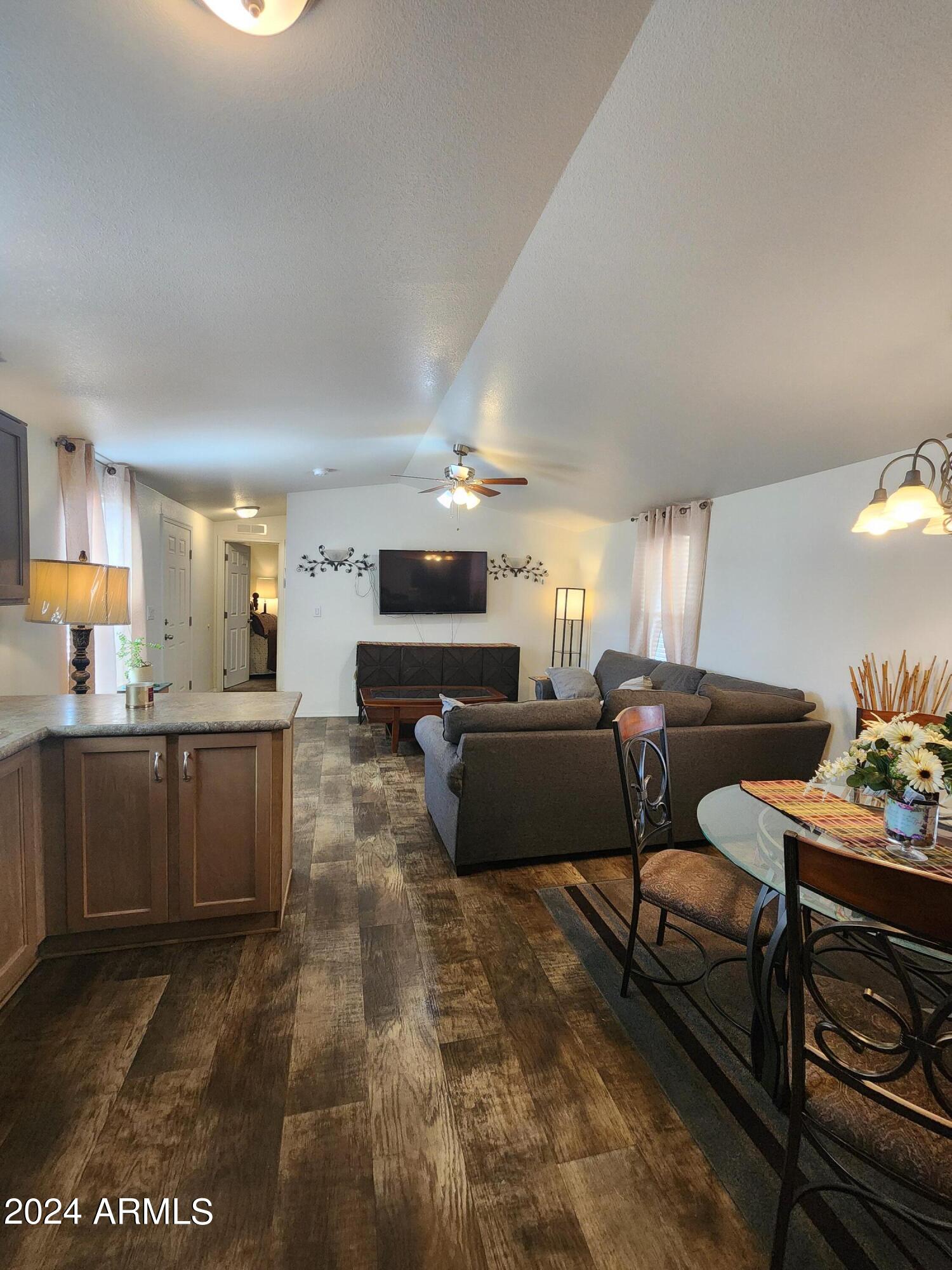 16005 North 32nd Street, Unit 31 Phoenix, AZ 85032 - Photo 11 of 48 a living room with furniture and a dining table with kitchen view
