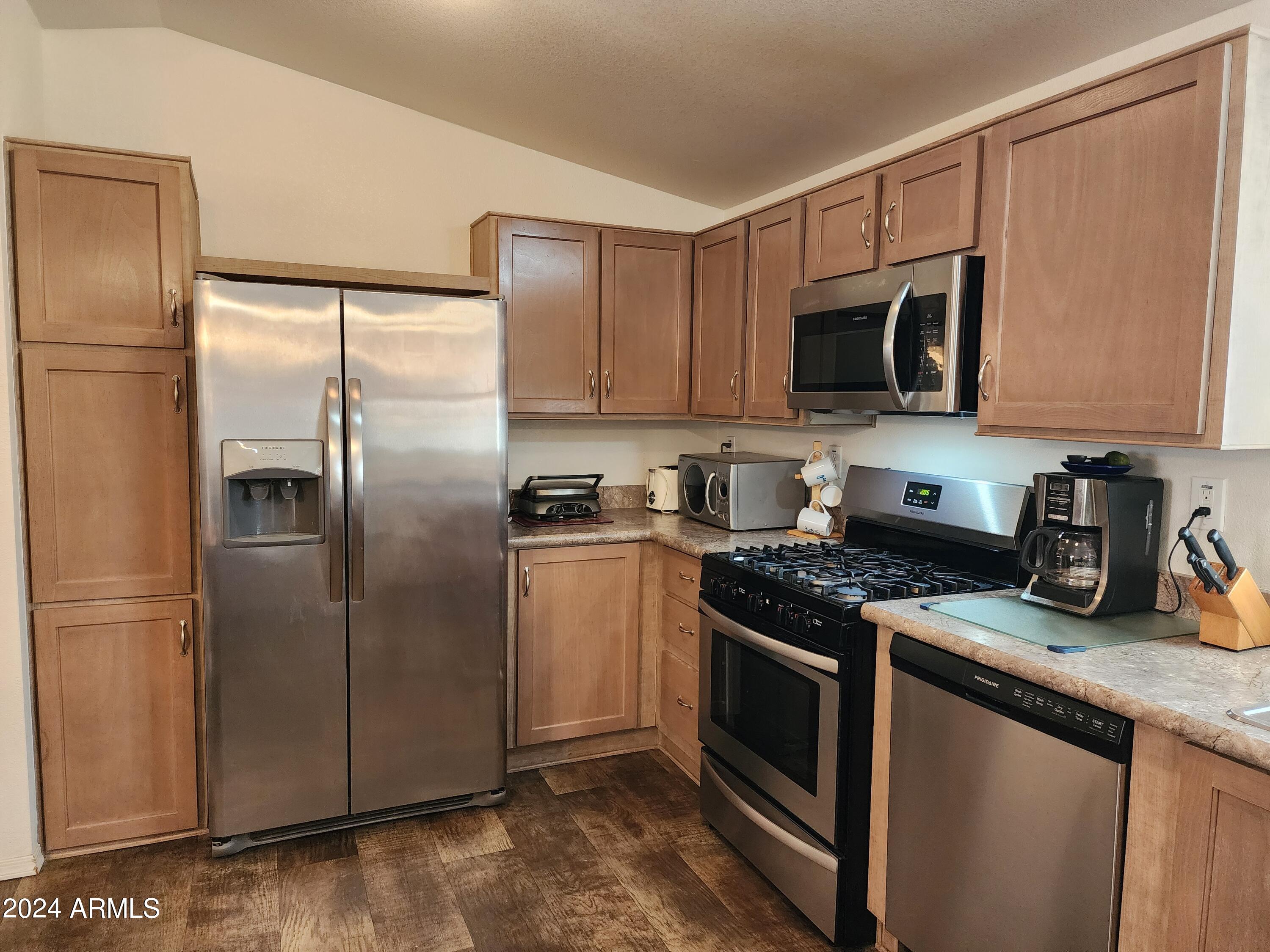 16005 North 32nd Street, Unit 31 Phoenix, AZ 85032 - Photo 14 of 48 a kitchen with stainless steel appliances granite countertop a refrigerator stove a sink and a microwave