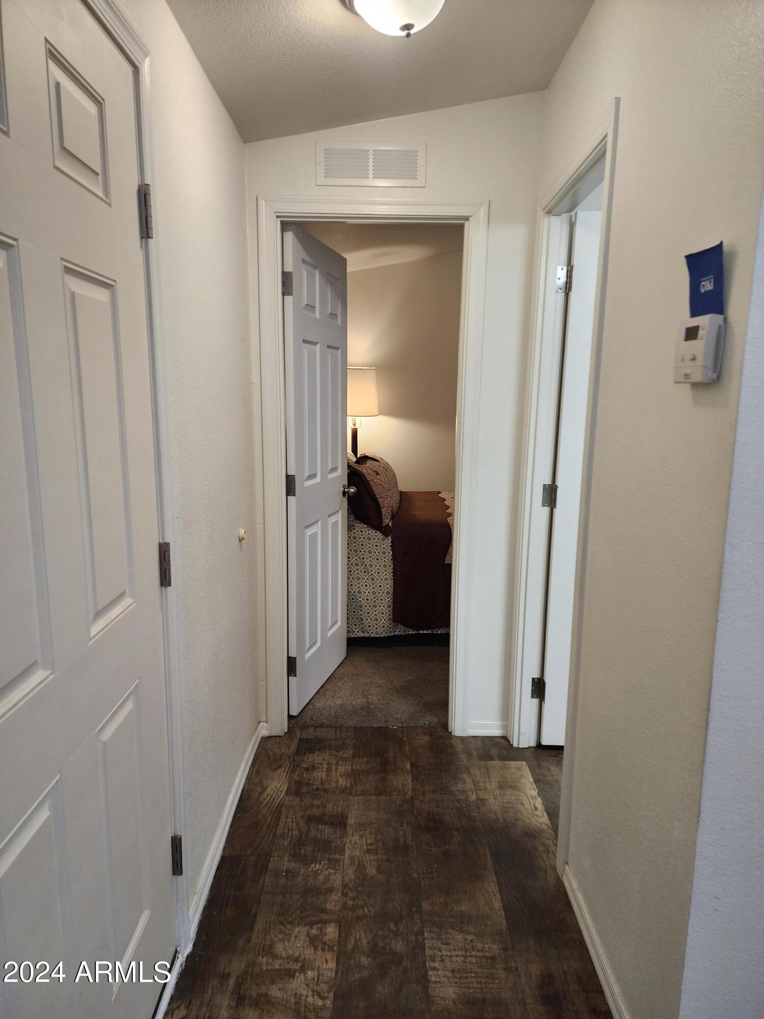 16005 North 32nd Street, Unit 31 Phoenix, AZ 85032 - Photo 17 of 48 a view of a hallway view with wooden floor and staircase