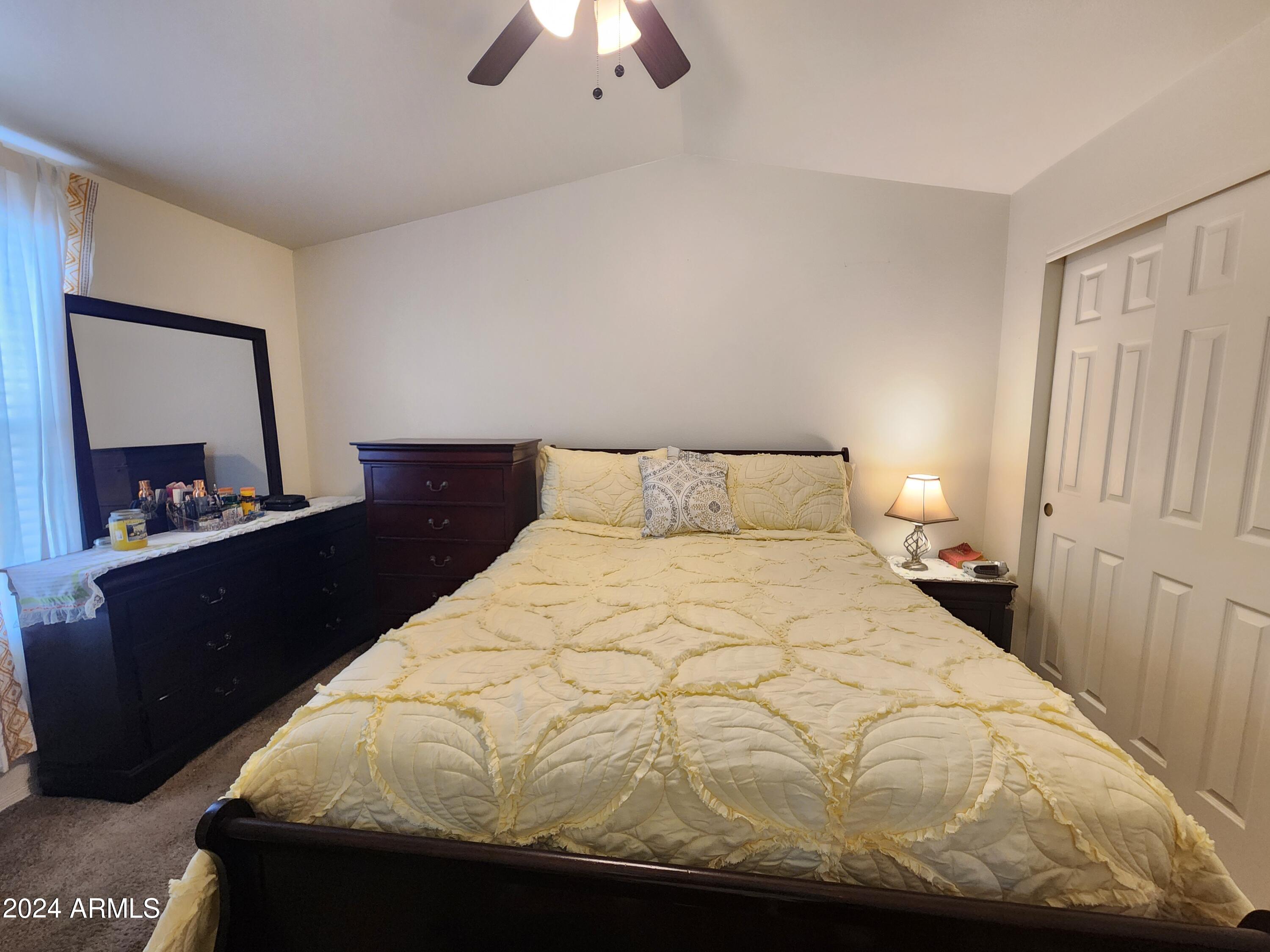 16005 North 32nd Street, Unit 31 Phoenix, AZ 85032 - Photo 18 of 48 a bedroom with a bed and a chandelier