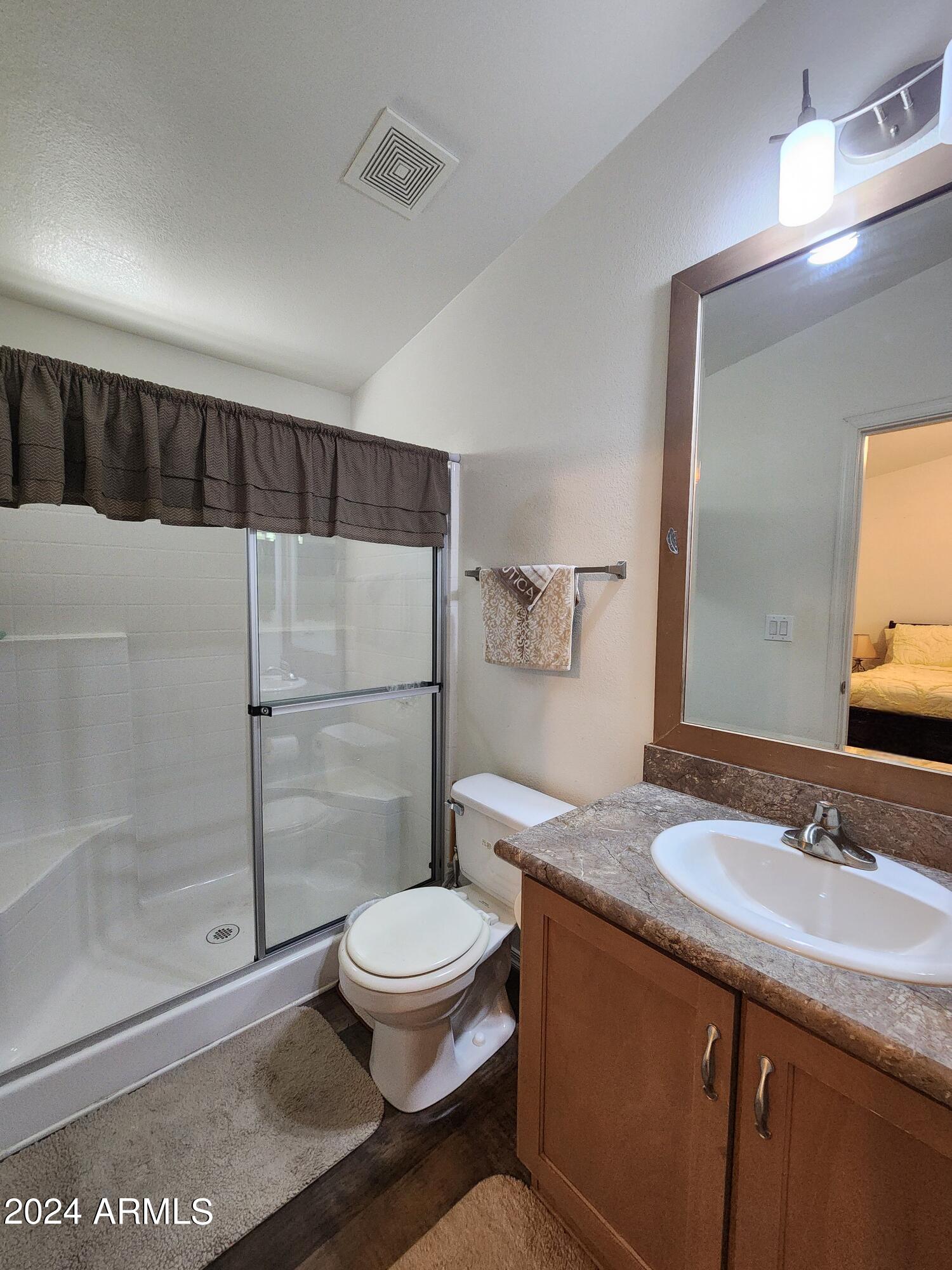 16005 North 32nd Street, Unit 31 Phoenix, AZ 85032 - Photo 22 of 48 a bathroom with a granite countertop sink toilet and shower