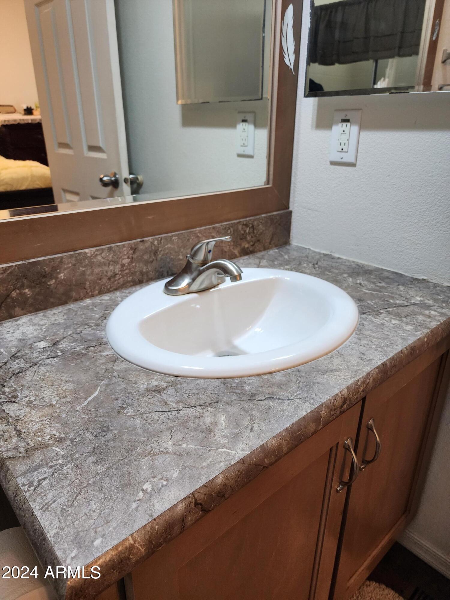 16005 North 32nd Street, Unit 31 Phoenix, AZ 85032 - Photo 24 of 48 a bathroom with a sink and a mirror