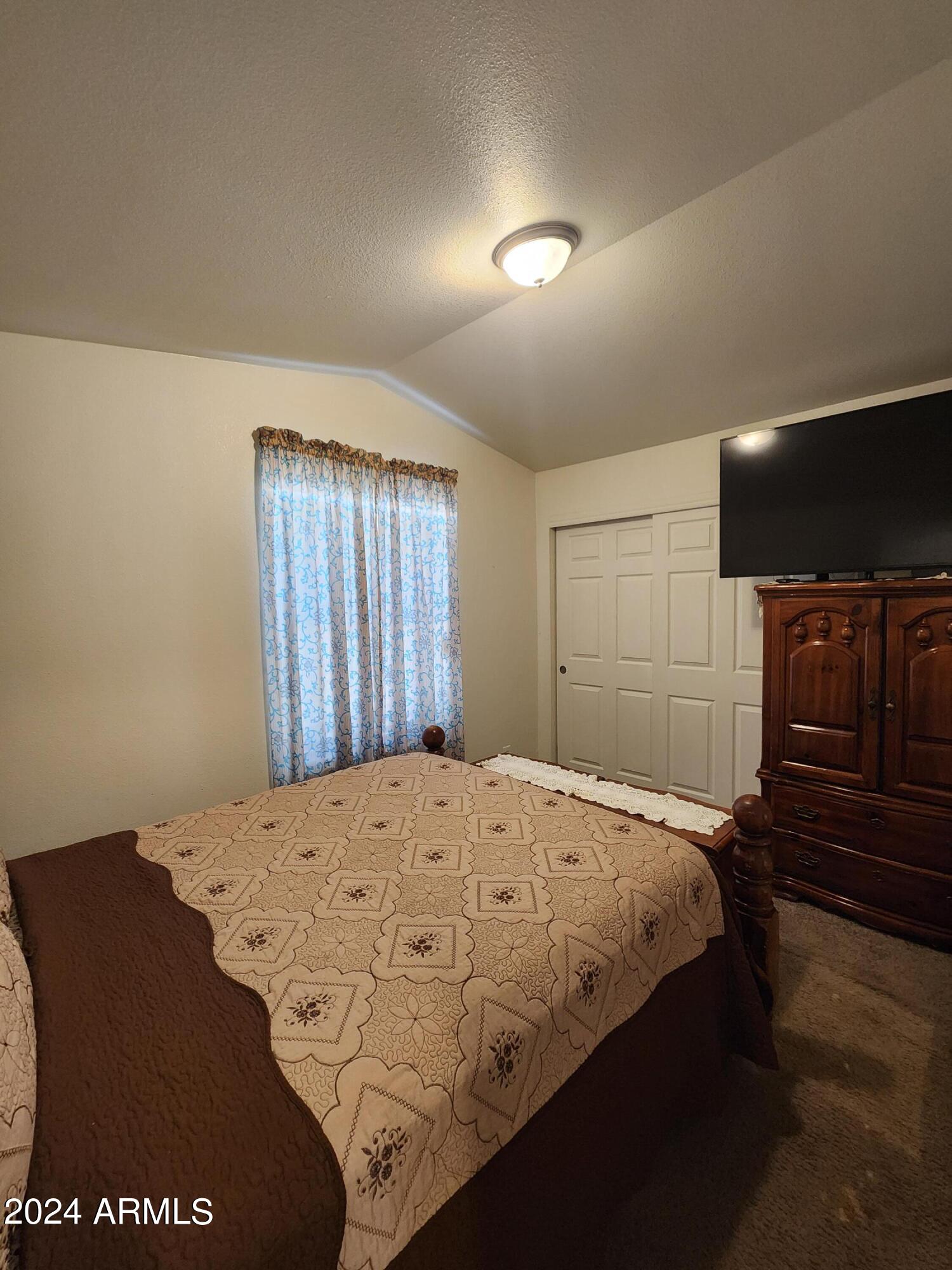 16005 North 32nd Street, Unit 31 Phoenix, AZ 85032 - Photo 26 of 48 a bedroom with a bed and a dresser