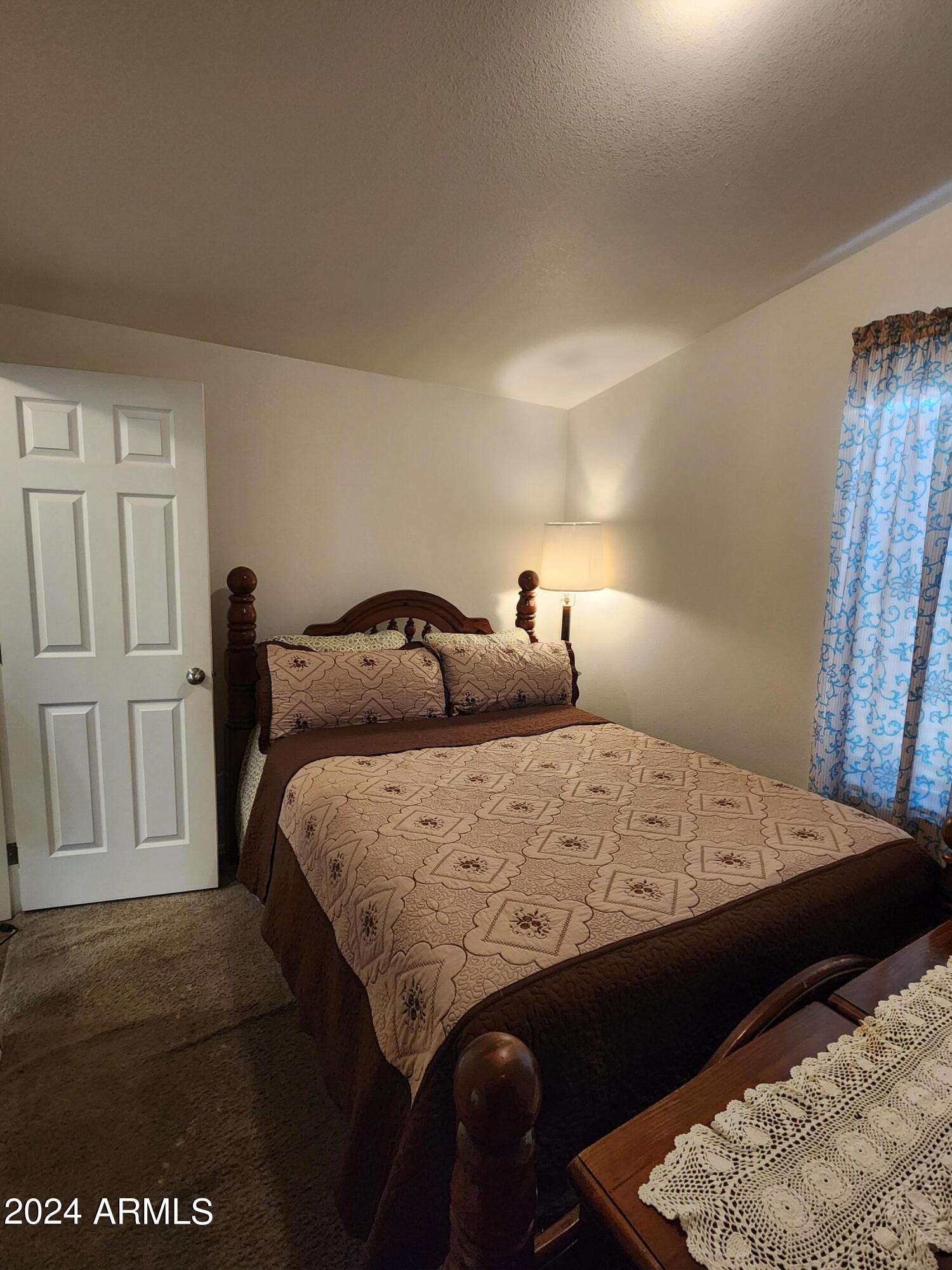 16005 North 32nd Street, Unit 31 Phoenix, AZ 85032 - Photo 27 of 48 a bedroom with a bed and a table