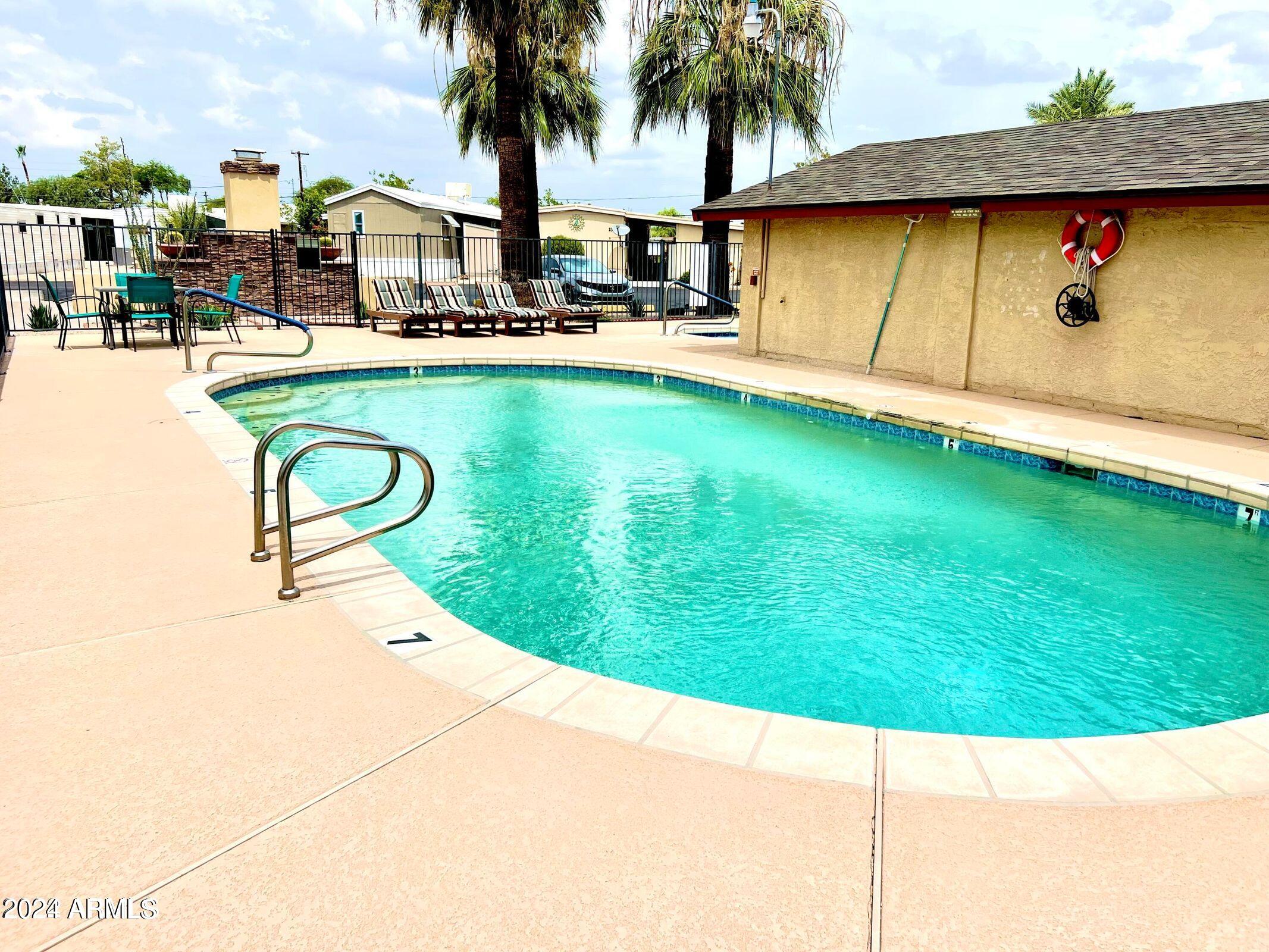 16005 North 32nd Street, Unit 31 Phoenix, AZ 85032 - Photo 35 of 48 a view of swimming pool with a table and chairs