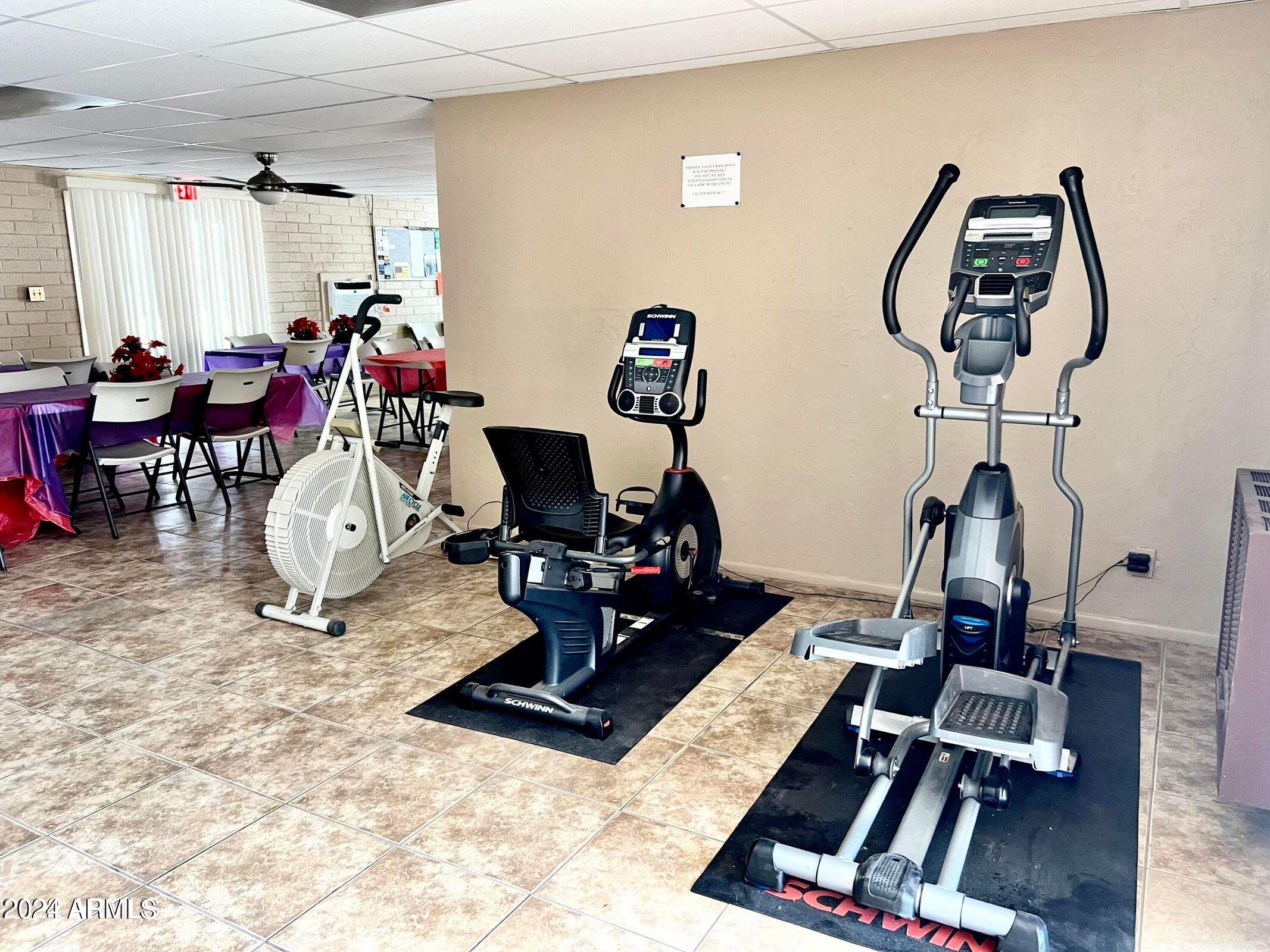 16005 North 32nd Street, Unit 31 Phoenix, AZ 85032 - Photo 40 of 48 a room with gym equipment and a view of living room